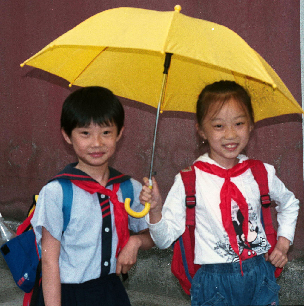 two Chinese children in school uniforms
