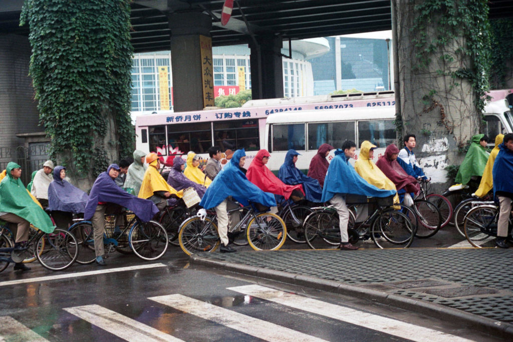 lots of bikers in colorful rain ponchos
