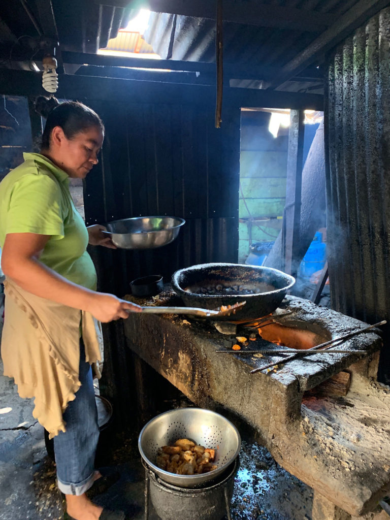 a Latina cooking on a simple kitchen