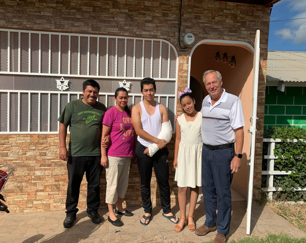 five people in front of a yellow brick house in Esteli Nicaragua