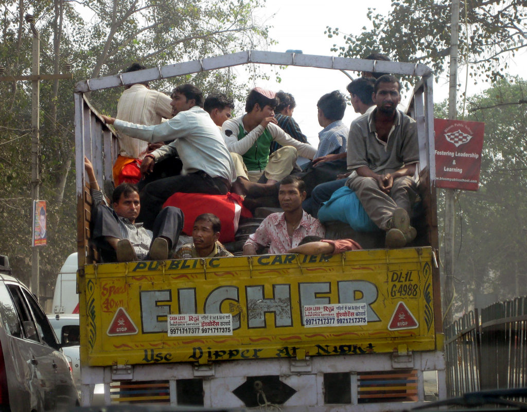 an open truck crowded with men