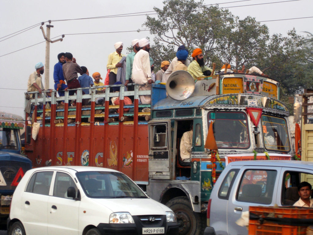 an open truck packed with men standing up