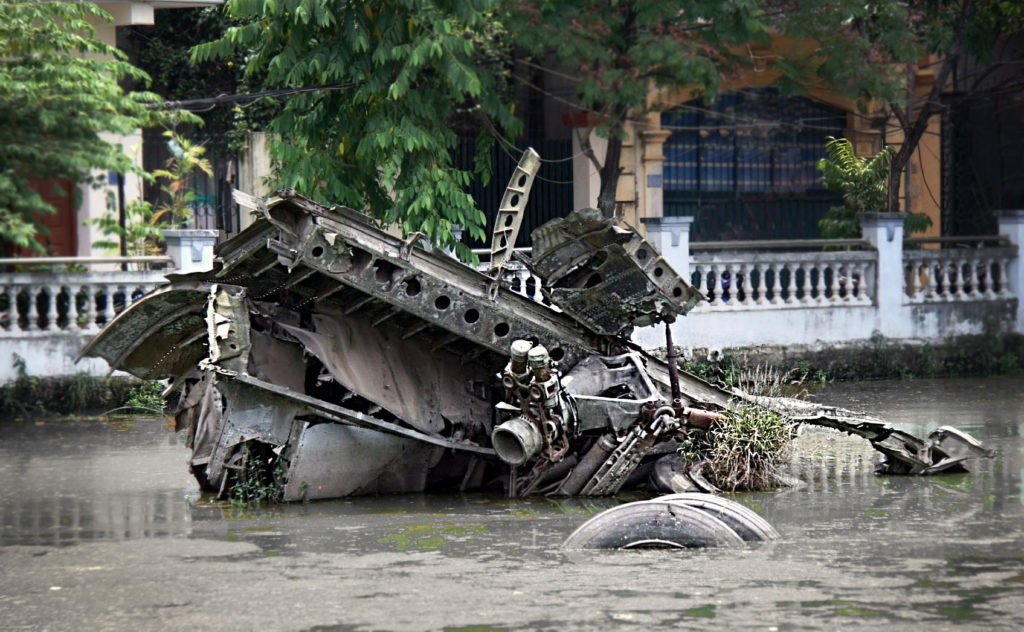 metal wreckage sticking up in a pond