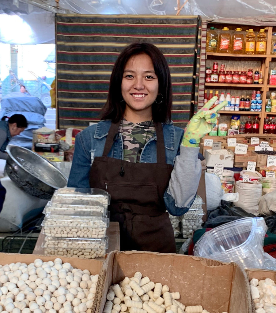 a young lady in a shop making the peace sign