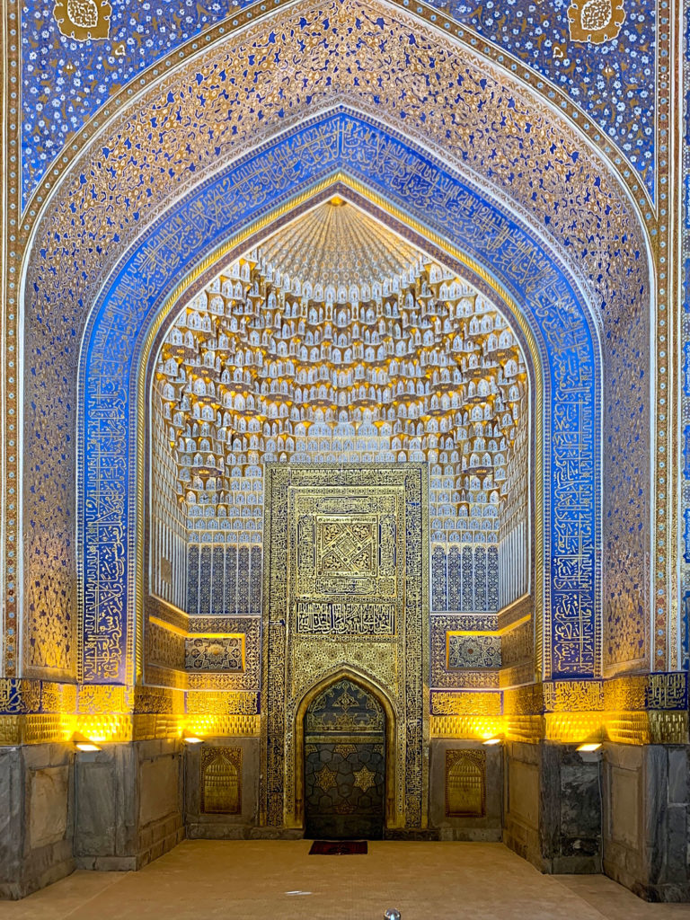 fancy tilework and carving in a tall Islamic arch