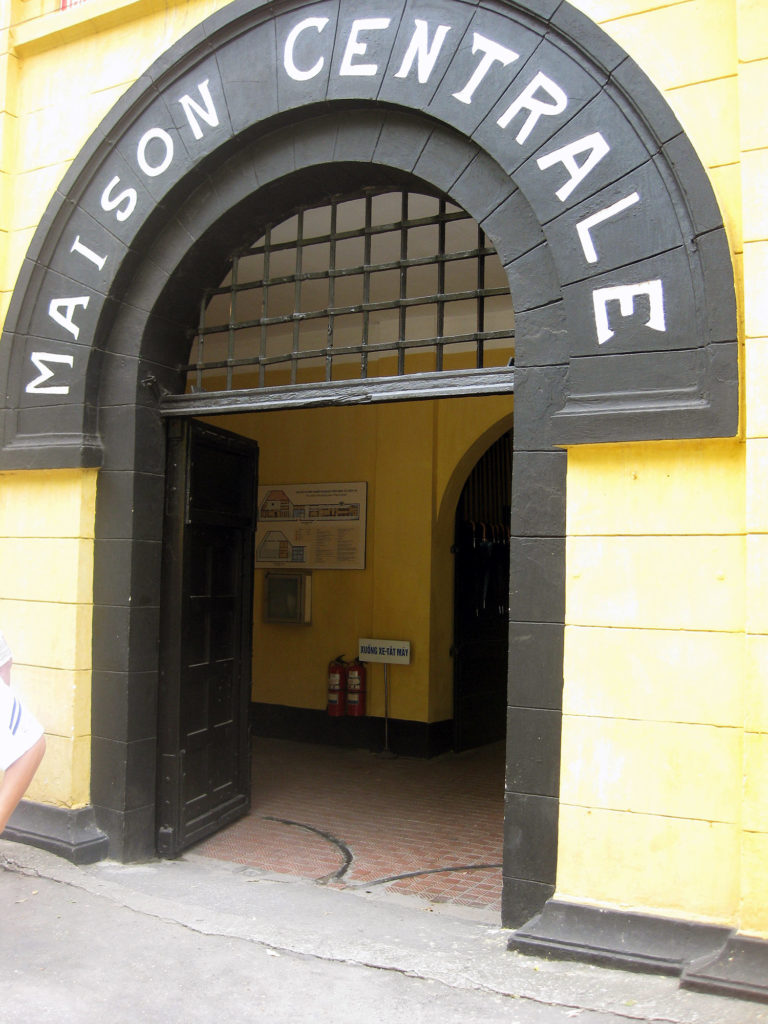 An arched doorway through a stone wall