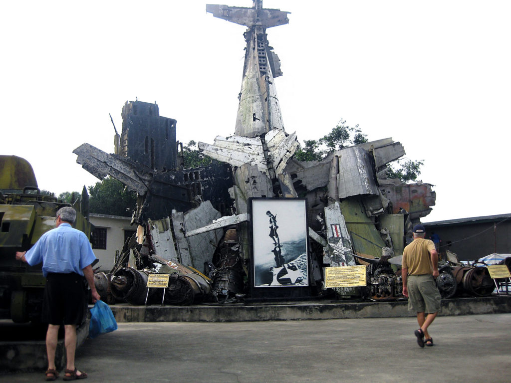 an outside junk pile display of destroyed American planes and tanks